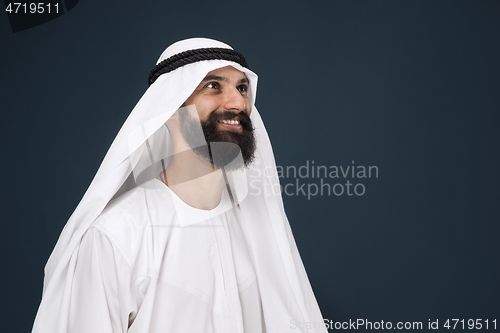 Image of Arabian saudi businessman on dark blue studio background