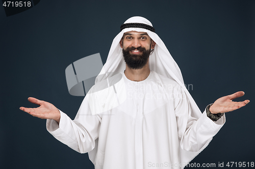 Image of Arabian saudi businessman on dark blue studio background