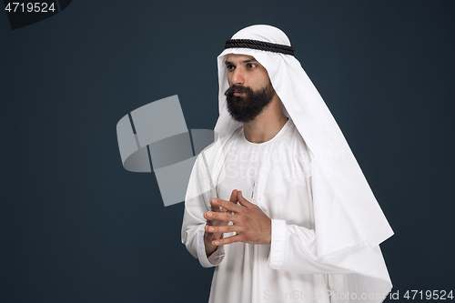 Image of Arabian saudi businessman on dark blue studio background