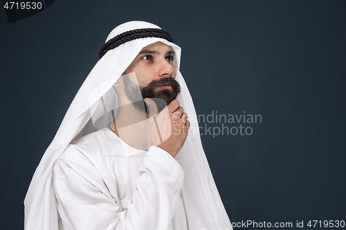 Image of Arabian saudi businessman on dark blue studio background