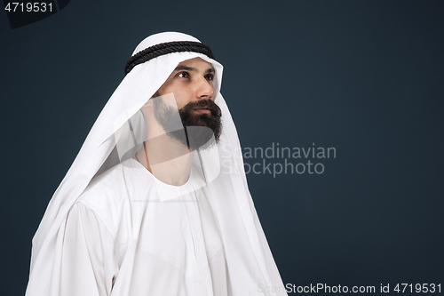 Image of Arabian saudi businessman on dark blue studio background