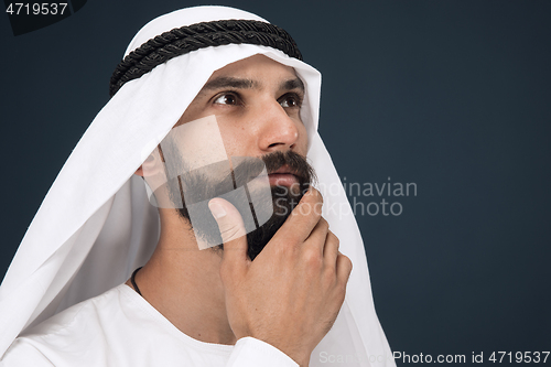 Image of Arabian saudi businessman on dark blue studio background