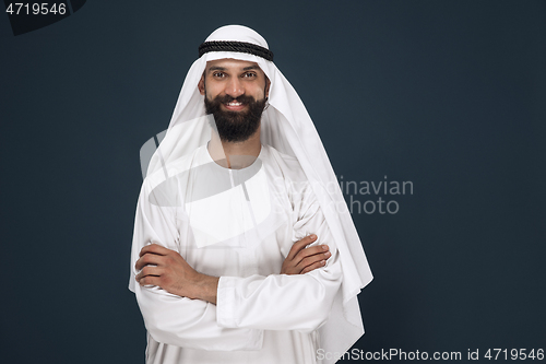 Image of Arabian saudi businessman on dark blue studio background