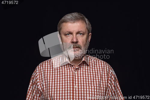 Image of Close up portrait of senior man isolated on black studio background