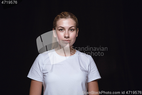 Image of Close up portrait of young woman isolated on black studio background