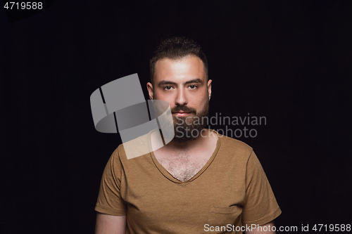 Image of Close up portrait of young man isolated on black studio background