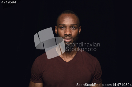 Image of Close up portrait of young man isolated on black studio background