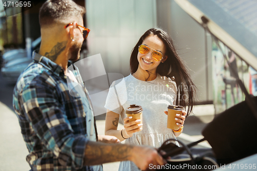 Image of Young couple preparing for vacation trip on the car in sunny day