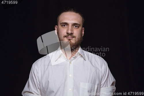 Image of Close up portrait of young man isolated on black studio background