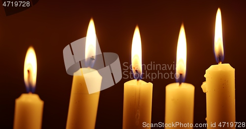 Image of Candles glowing against dark background