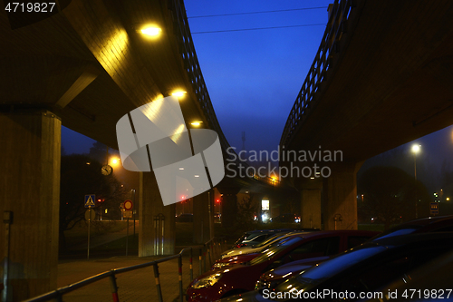 Image of car parking near the metro overpass at night 