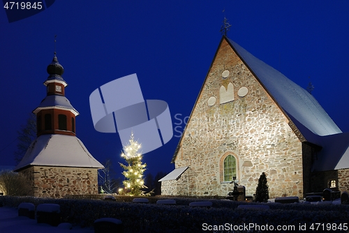 Image of christmas night scenery in Finland, church in snow, xmas tree