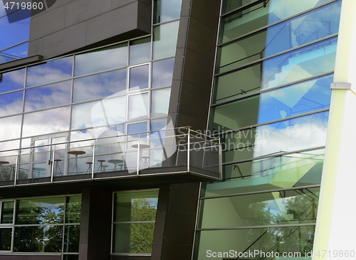 Image of facade of a modern building with a reflection of the sky in the 