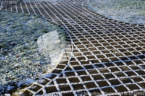 Image of first snow-covered cobblestone path 