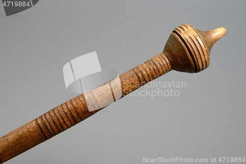 Image of vintage wooden spindle on gray background