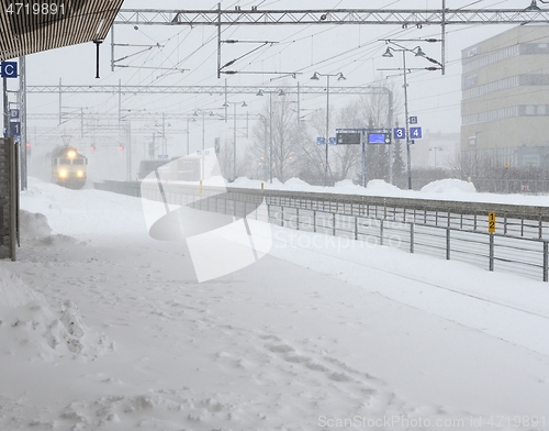 Image of the train arrives at the station during a blizzard