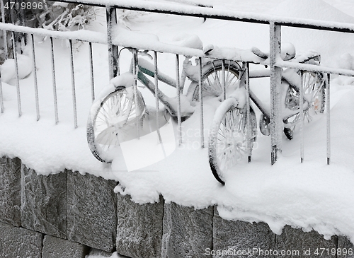 Image of two snow covered bikes on the coast 