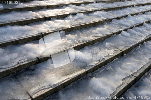 Image of stone staircase covered with ice in the city