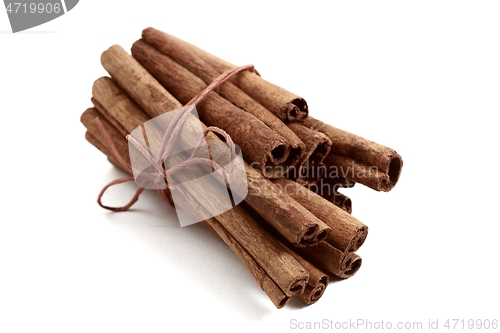 Image of bunch of cinnamon sticks on a white background