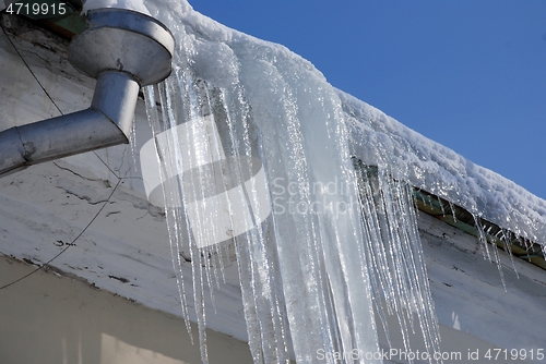 Image of large icicles hanging from the roof