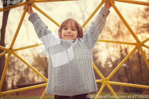 Image of cute little boy having fun in playground