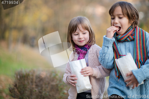 Image of kids in park eating popcorn in park