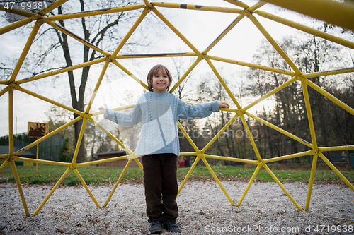 Image of cute little boy having fun in playground