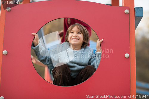 Image of cute little boy having fun in playground