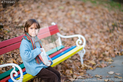 Image of cute little boy in park eating popcorn