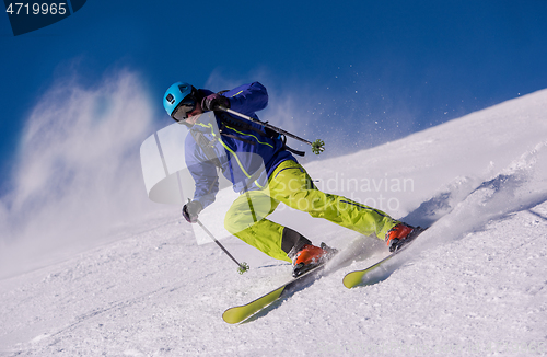 Image of Skier having fun while running downhill