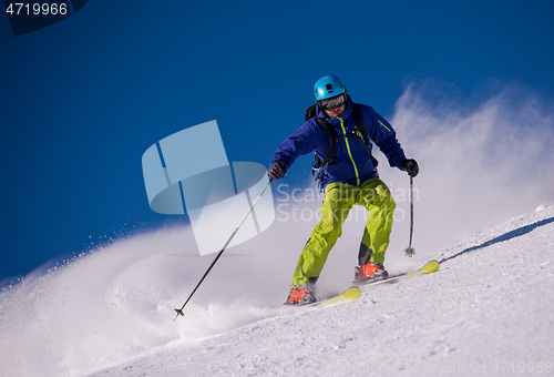 Image of Skier having fun while running downhill
