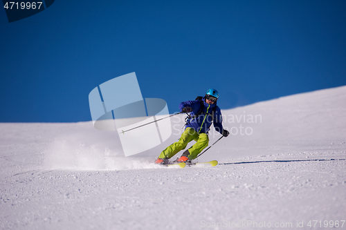 Image of Skier having fun while running downhill