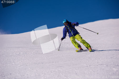 Image of Skier having fun while running downhill