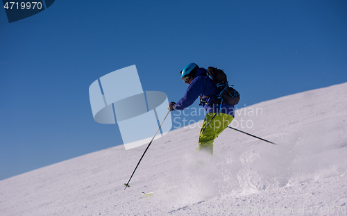 Image of Skier having fun while running downhill