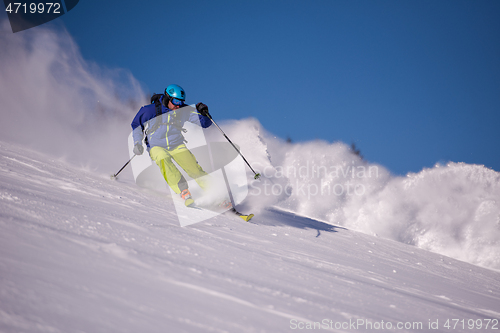 Image of Skier having fun while running downhill