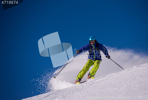 Image of Skier having fun while running downhill