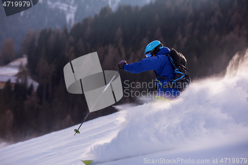 Image of Skier having fun while running downhill