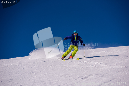 Image of Skier having fun while running downhill