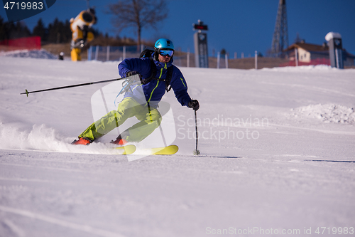 Image of Skier having fun while running downhill