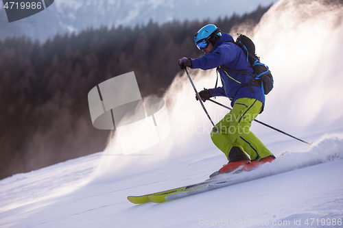 Image of Skier having fun while running downhill