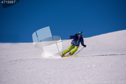 Image of Skier having fun while running downhill