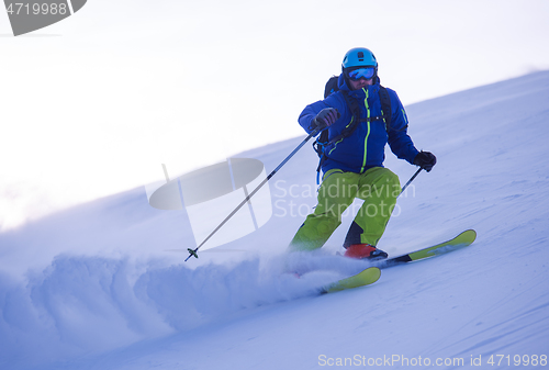 Image of Skier having fun while running downhill