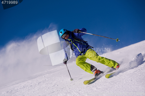 Image of Skier having fun while running downhill