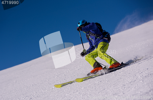 Image of Skier having fun while running downhill