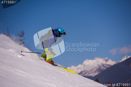 Image of Skier having fun while running downhill