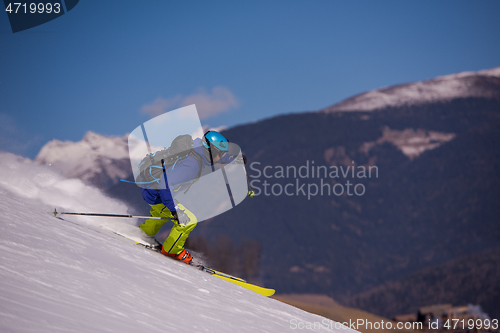 Image of Skier having fun while running downhill