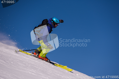 Image of Skier having fun while running downhill