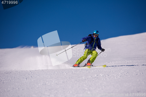 Image of Skier having fun while running downhill