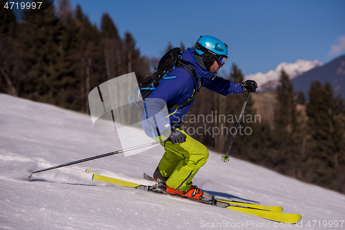 Image of Skier having fun while running downhill