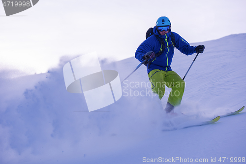 Image of Skier having fun while running downhill